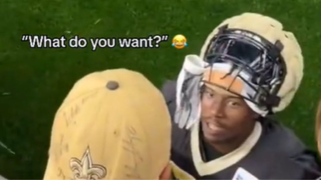 A football player talking to a young NFL fan.