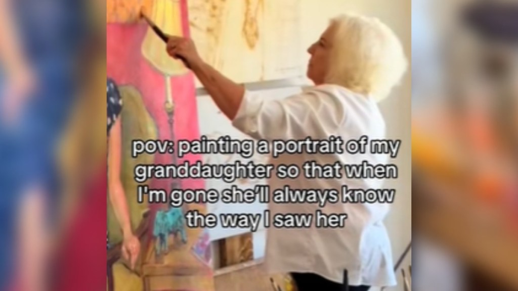Close up of a woman painting. We can only see part of the painting, giving us a glimpse of a brightly colored room, a side table, and a woman's arm. Text on the image reads: pov: painting a portrait of my granddaughter so that when I'm gone she'll always know the way I saw her