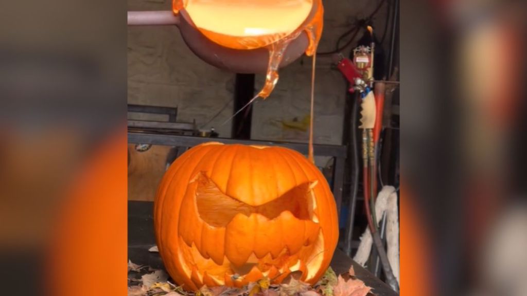 A jack-o'-lantern about to be filled with molten glass.