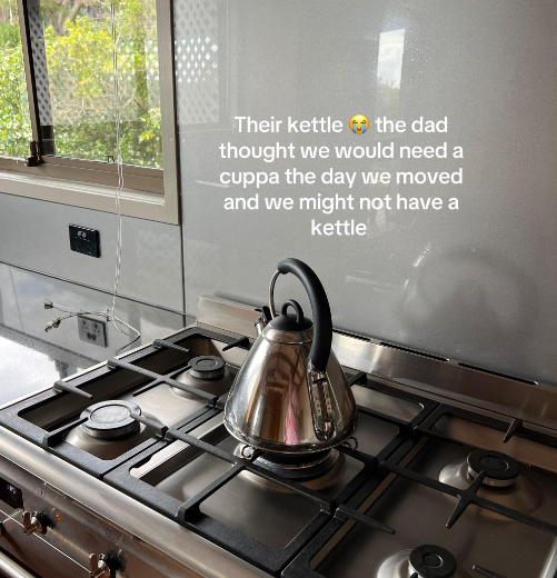 A silver kettle on a kitchen stove.