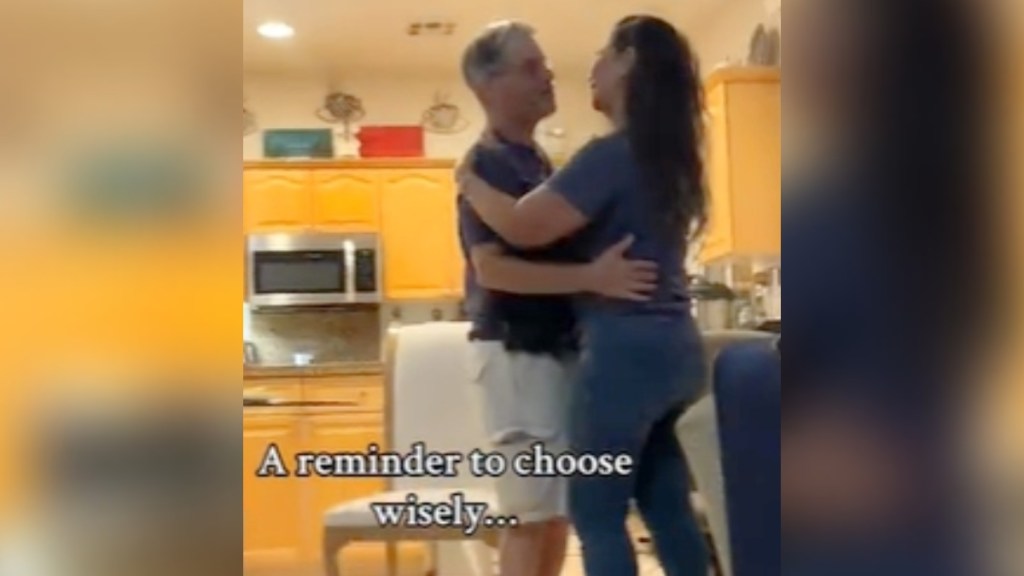 A man and woman dance closely in their kitchen, looking into each other's eyes with love. Text on the image reads: A reminder to choose wisely...