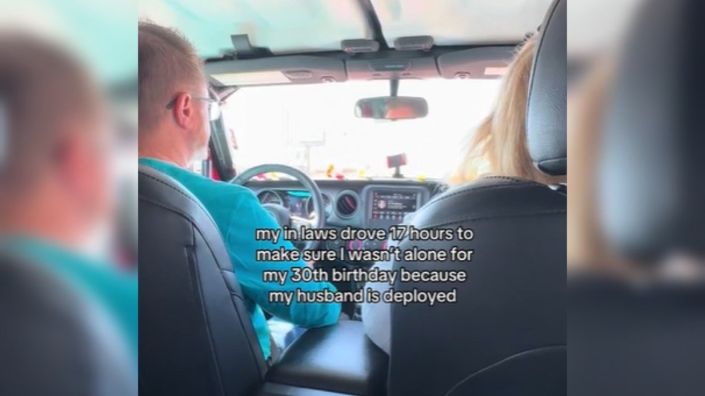 View from the backseat of a car. A man is driving and a woman is in the passenger seat. Text on the image reads: My in laws drove 17 hours to make sure I wasn't alone for my birthday