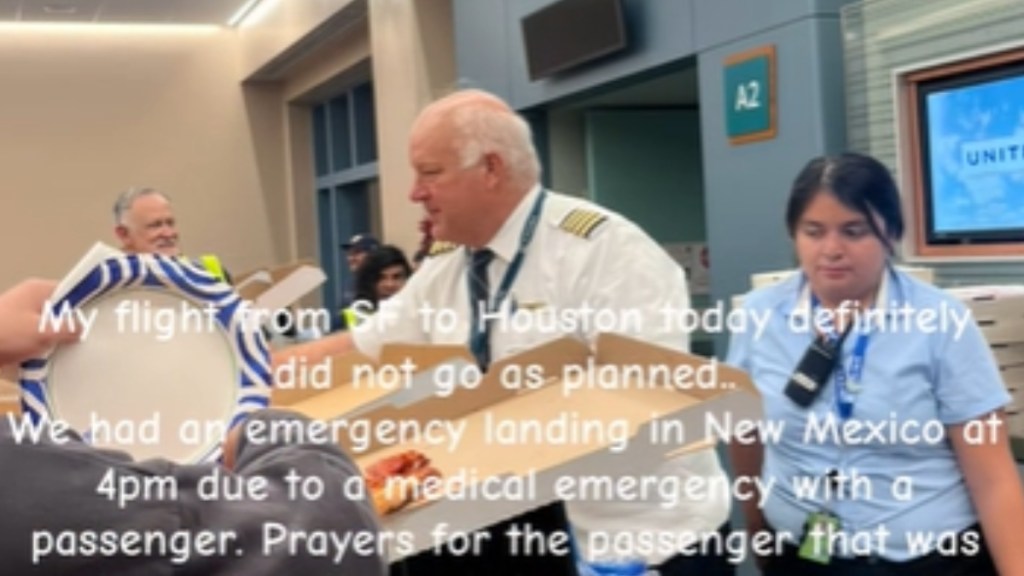 Pilot pictured handing out pizza as part of his act of kindness. Text on the image reads: My flight from SF to Houston today definitely did not go as planned… we had an emergency landing in New Mexico at 4pm due to a medical emergency with a passenger. Prayers for the passenger that was -
