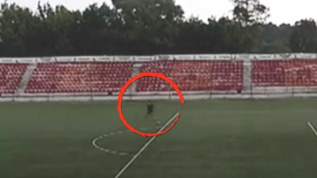 Image from a camera placed on a soccer field in Russia. A red circle highlights the player getting ready to kick a ball
