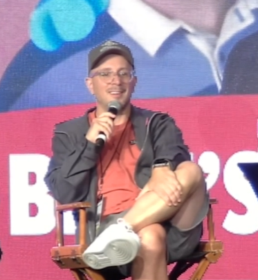 Steve from "Blue's Clues" speaking into a microphone.