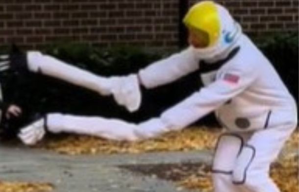 Image shows an astronaut being sucked into a black hole costume, with spaghettified arms.