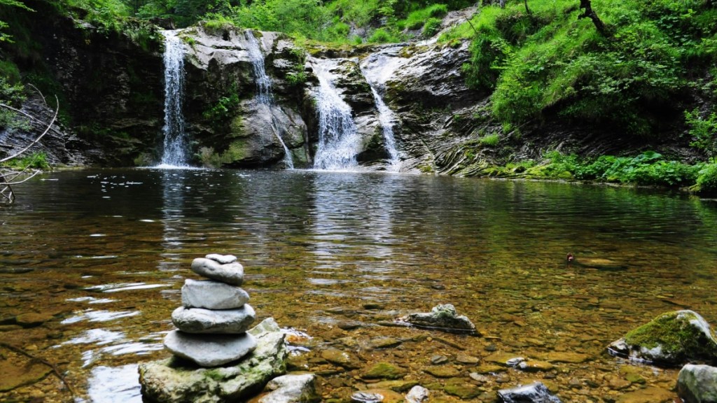 View of a creek with a waterfall at a distance