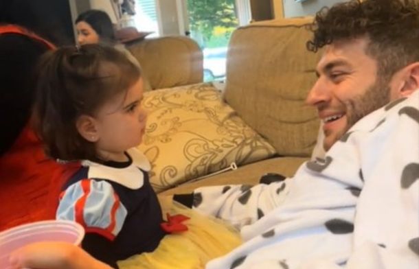 Image shows an uncle having a conversation with his cute niece.