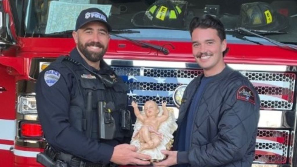 Image shows firefighters holding up the stolen baby Jesus that was returned.