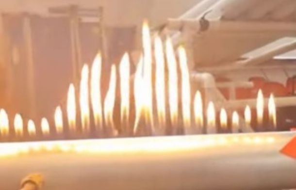Image shows fire jumping to the sound waves produced by a trumpet.