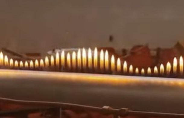 Fire sound waves pulsing while a trumpet player plays jazz music into a hollow tube.