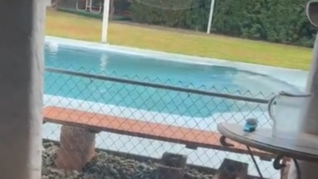 Close up of a pool. The water is rising and starting to overflow on the right side