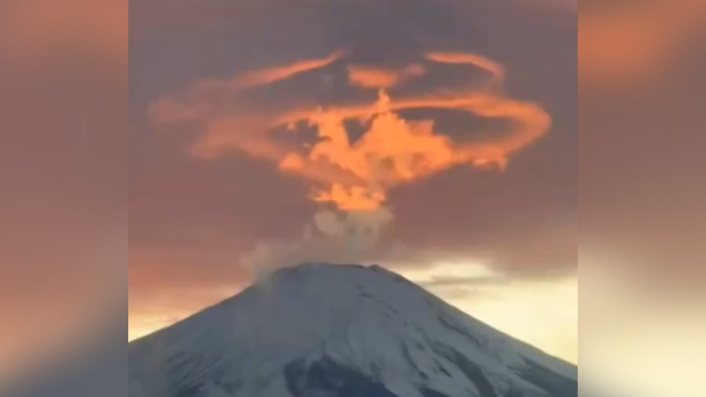 View of Mount Fuji. A red cloud is starting to form above the peak