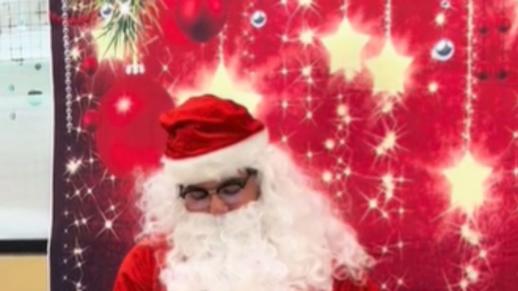 A man dressed as Santa Claus looking down.