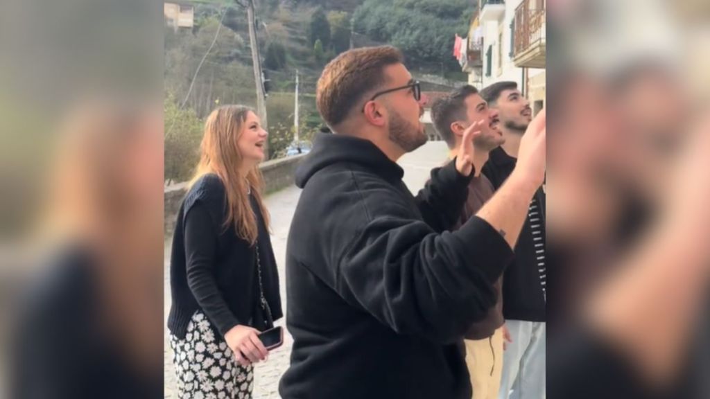 A group of friends singing outdoors.
