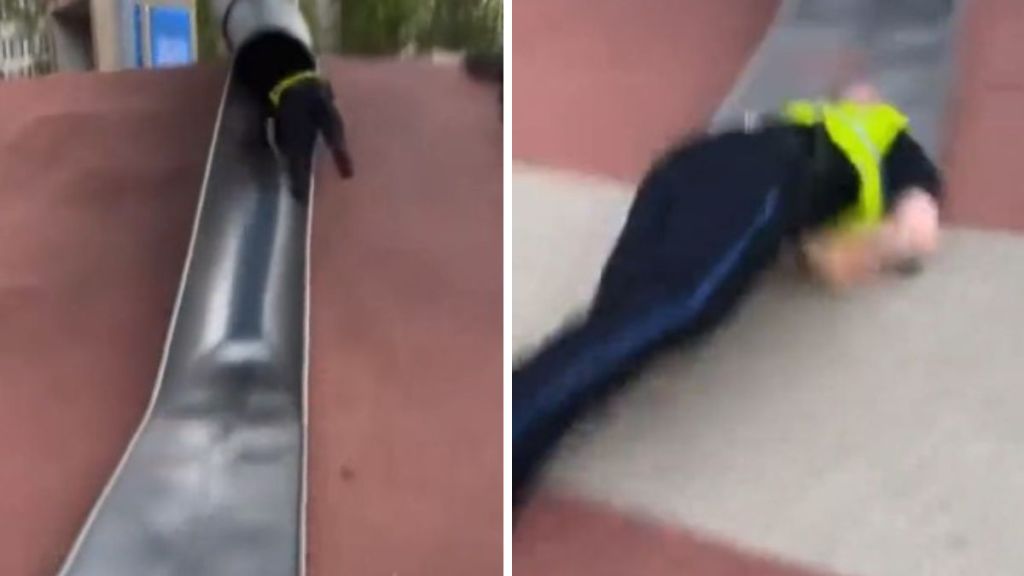 A Boston cop, testing a slide after complaints catapults out of the tube and down the slide.