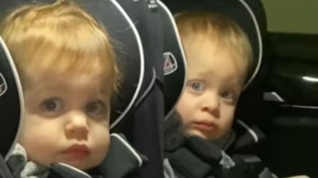 Twin toddlers showing instant regret about becoming big sisters when the baby cries.