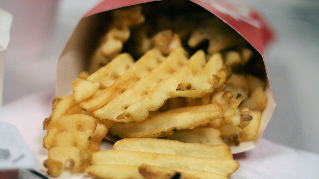 Close up of a Chick-fil-A waffle fries inside their container. The container is on its side, so the fries are slightly spilling out