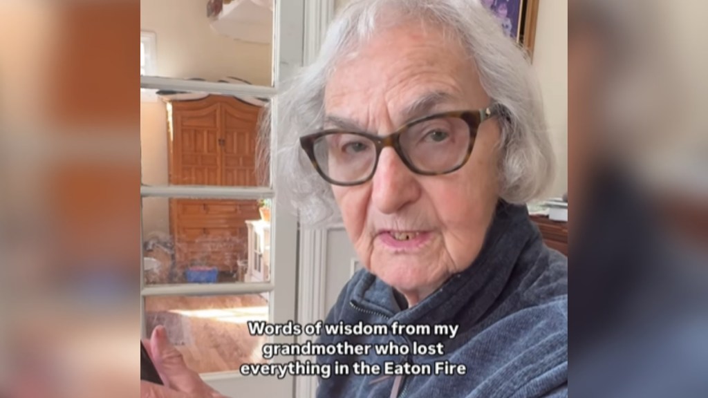 Close up of an elderly woman as she sits at a table in a home and talks. Text on the image reads: Words of wisdom from my grandmother who lost everything in the Eaton fire