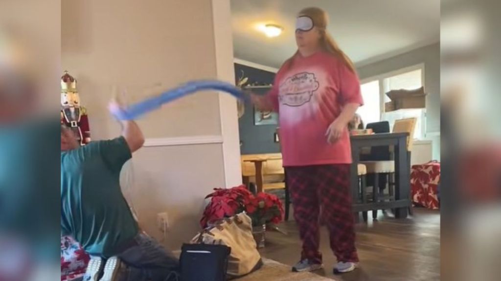 Image shows a cable man at the mercy of a blindfolded Nana playing whack-a-mole with a pool noodle.