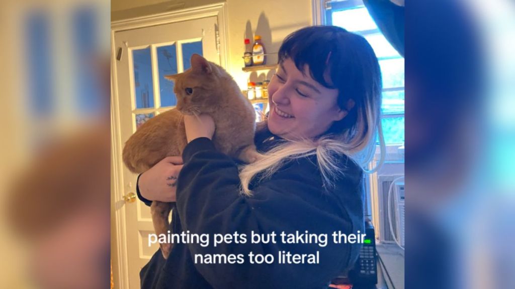 A woman holding a cat in her arms.