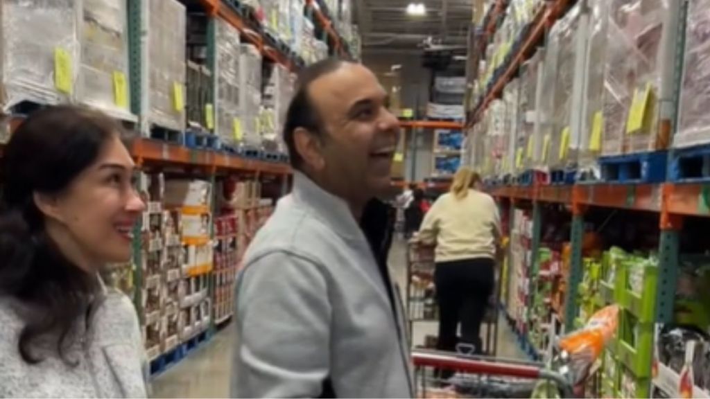 A mom and dad smiling in a store.
