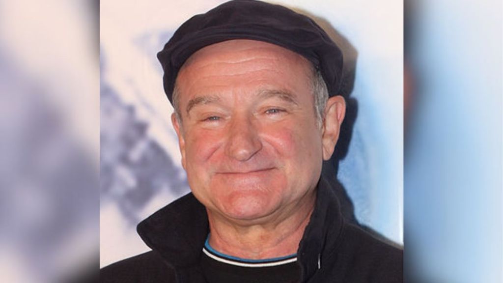 Robin Williams wearing a hat and smiling.