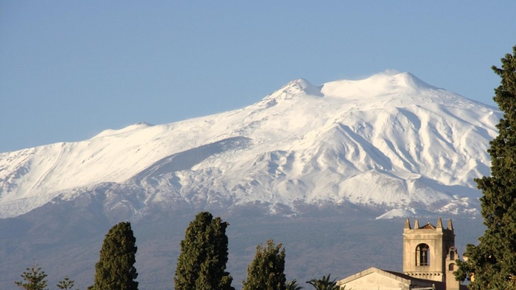 Distant view of a snow-covered Mount Etna in Italy