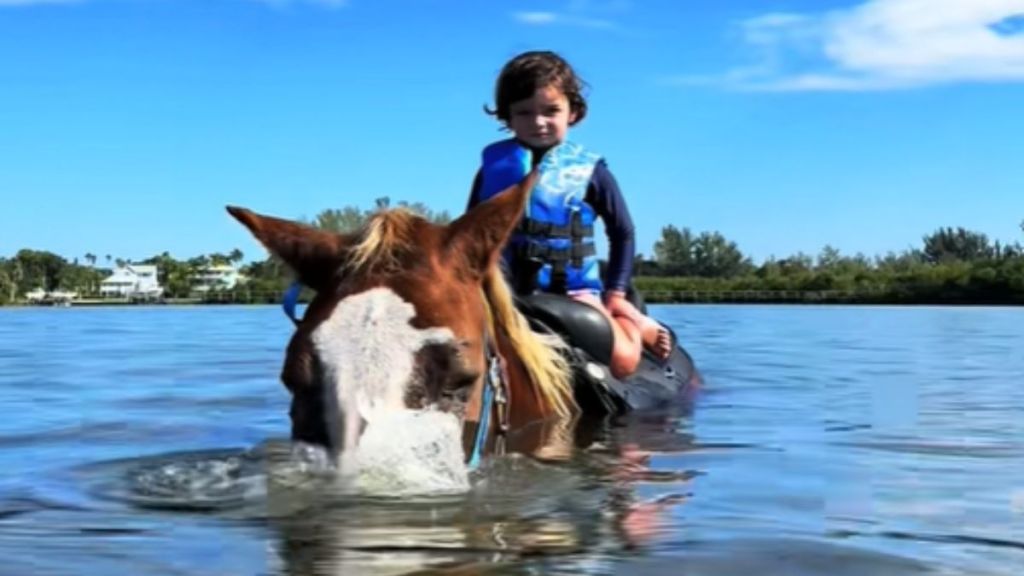 Images shows beach horse Naomi blowing bubbles.