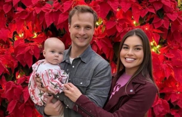 Dahlia, Ian, and Jessica McNamara. Ian has a "Superman forehead lock" and is showing the world what a girl dad he is.