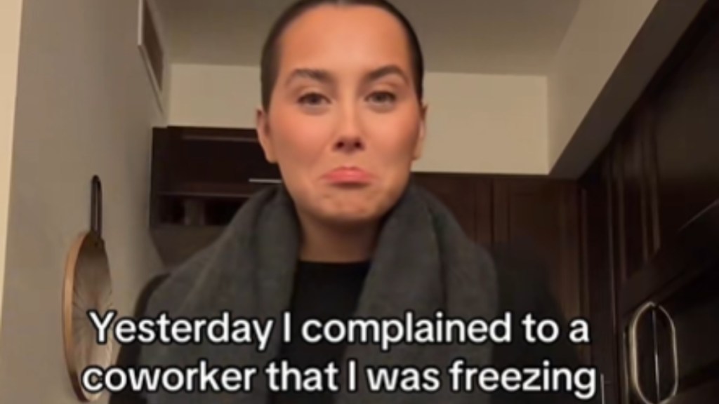 Close up of a woman standing as she looks into the camera. She pouts, emotional look in her eyes. Text on the image reads: Yesterday I complained to a coworker that I was freezing