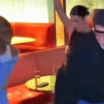 Joey Fatone dances with three NSYNC fans. Everyone is smiling.