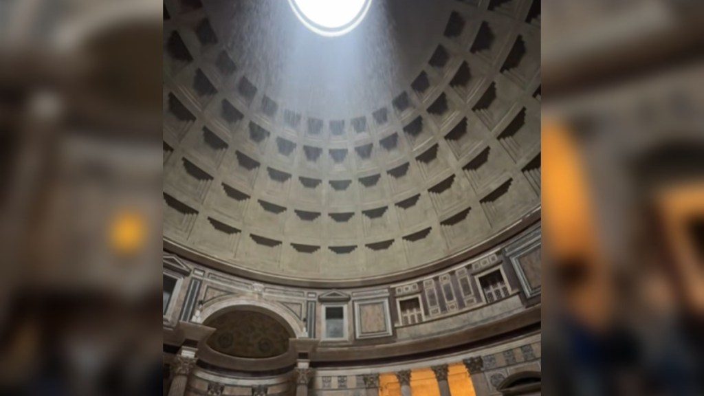 View from below of the oculus in the Roman Pantheon. Rain falls through the oculus