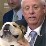 Image shows Senator Jim Justice with his English bulldog Babydog.