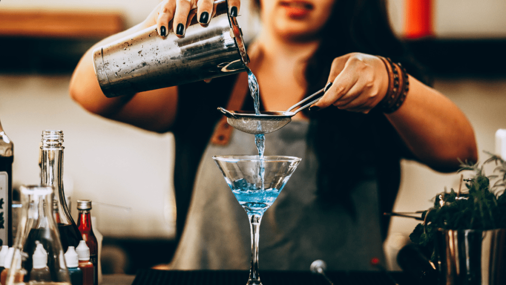a bartender makes a drink