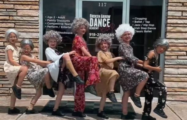 Image shows six dancers modeling their costumes before a dance recital.