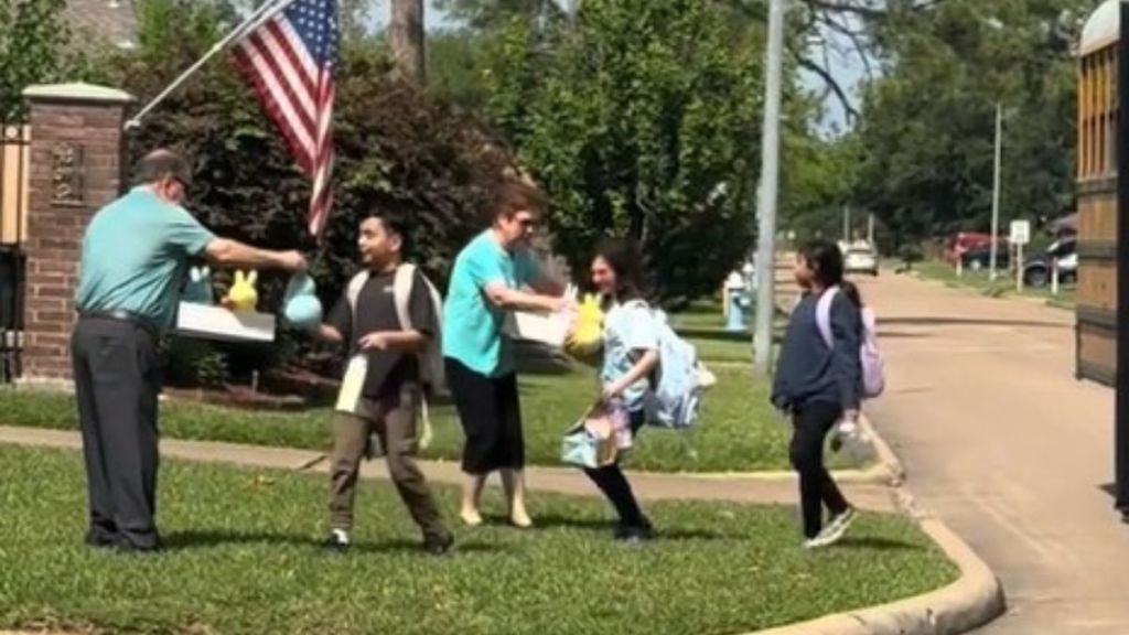 Elderly neighbors meeting the kids at the school bus with Easter baskets.