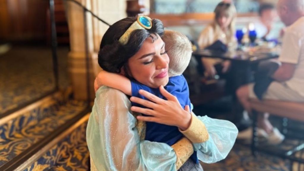Jasmine hugging Maverick at Disney World.
