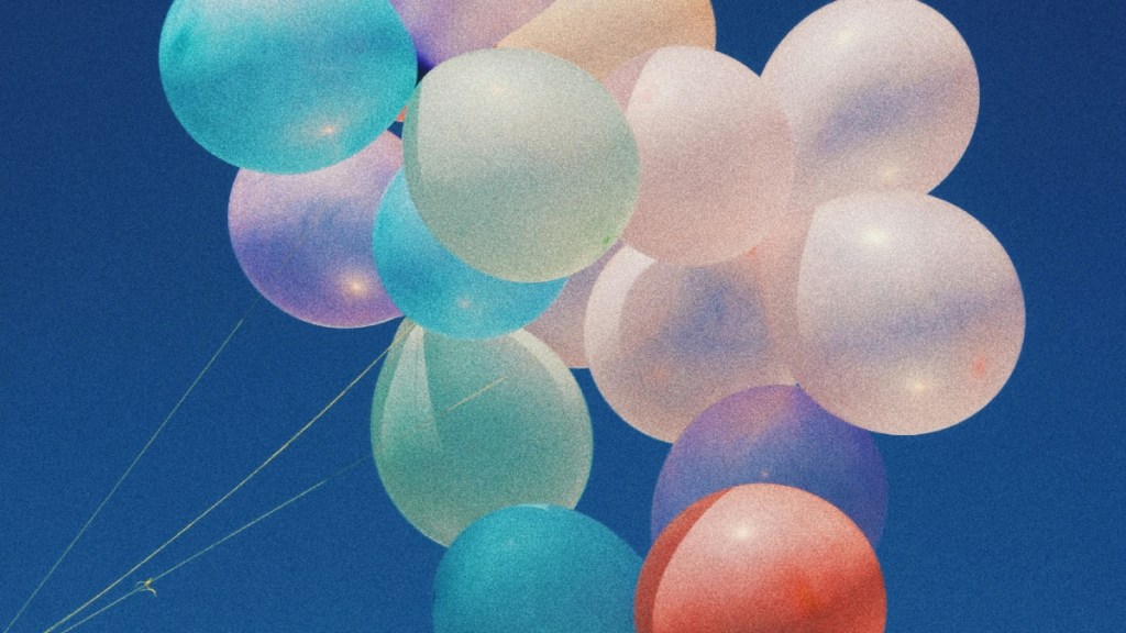 A bundle of pretty, colorful balloons. A beautiful, vibrant blue sky serves as their backdrop