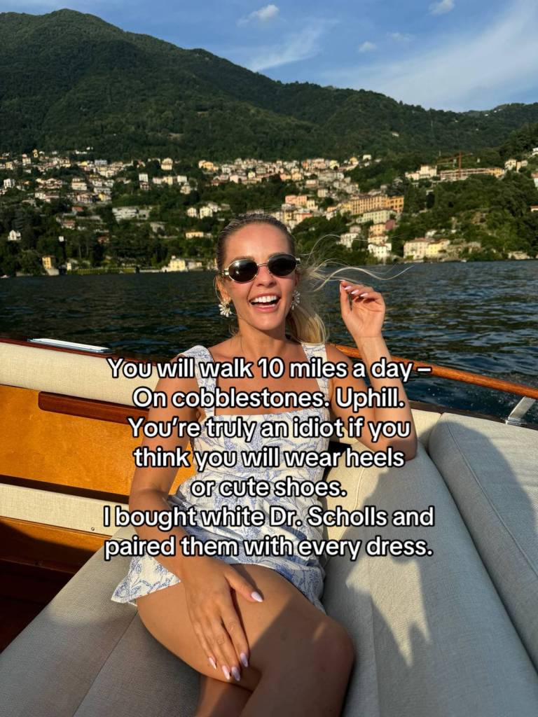 Abby smiles wide as she sits on a boat. She's wearing sunglasses. Text on the image reads:
You will walk 10 miles a day - on cobblestone. Up hill. You're truly an idiot if you think you will wear heels or cute shoes. I bought white Dr. Scholls and paired them with every dress