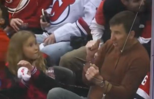 Image shows Eli Mannings' daughter looking at him during a hockey game.