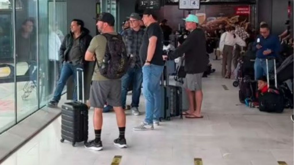 Image shows several dads looking out a window at an airport experiencing dad life.