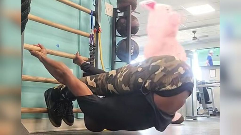 While recording a fitness video, a funny thing happened at the gym. A pig walked through his video.