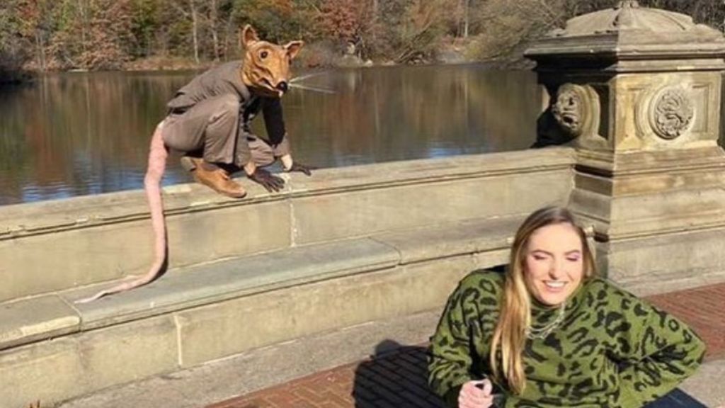 The Rat Man of New York photobombing a wheelchair bound hiker in Central Park.