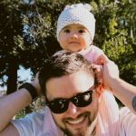 Image shows Joel Woods with his daughter celebrating the release of him singing his new song to her.