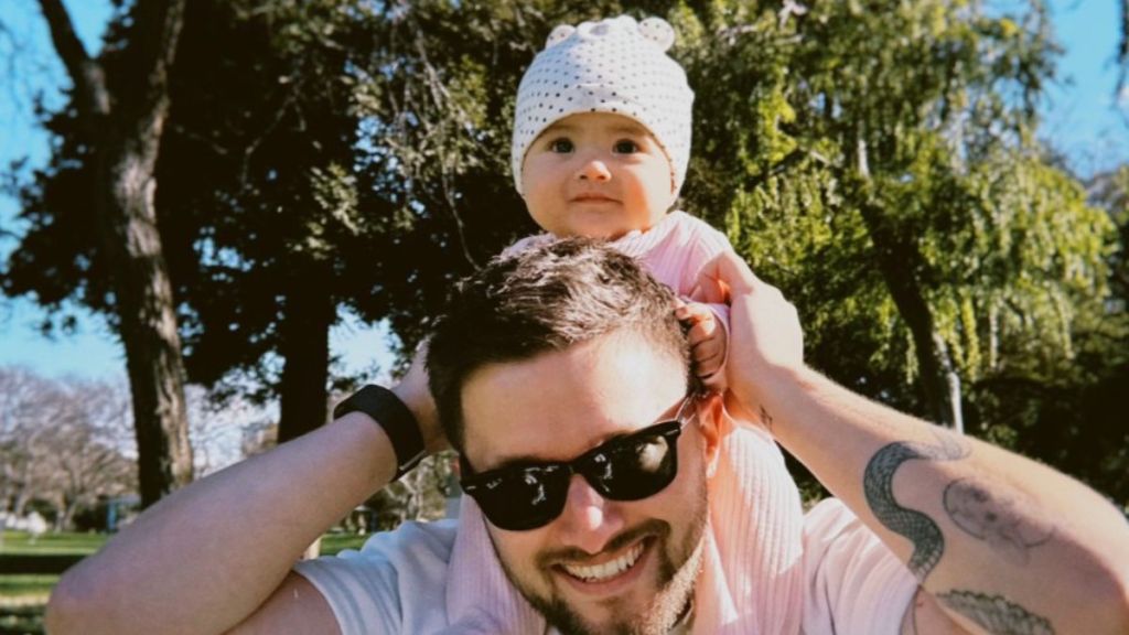 Image shows Joel Woods with his daughter celebrating the release of him singing his new song to her.