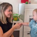 Teaching social skills is an important of parenting. Image shows a mom teaching her daughter how to shake hands.