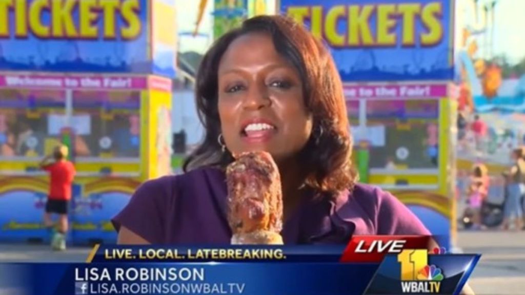 Reporter accidentally uses a turkey leg for a microphone during a live broadcast.