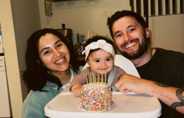Image shows Joel Woods, his wife, and their daughter.