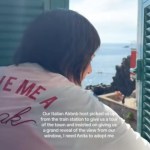 View from behind of a woman as she opens a window, partially revealing the stunning view. Text on the image reads: Our Italian Airbnb host picked us up from the train station to give us a grand reveal of the view from our window, I need Anita to adopt me